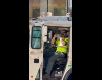 Garbage truck driver dance to music flute gesture 