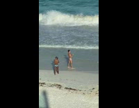 Guy brief side pose hold hair beach