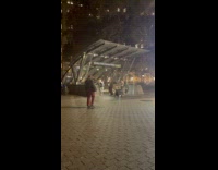 Woman lies down outside the subway station