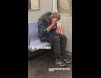 Man do own haircut with scissors subway