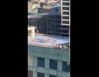 Three people tiktok dance at rooftop helipad