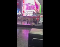 Two girls pose on NYC street while raining