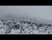 Girl on mountain surrounded by snow and fog