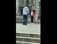Lady plays violin on sidewalk 