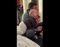 Baby climb to dad and bite donut