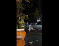 Man ride scooter step on pizza boxes