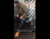 man smoking and spitting on floor green jacket