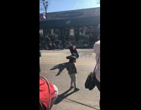 Guy crosses tape to pose in street 