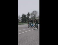 White hazmat suit guy rides blue bicycle 