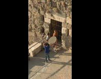 Woman black dress door grills brick pictorial