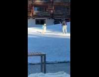Woman in a white outfit kneels with a box