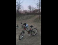 Guy rides bicycle up wood pallets fail