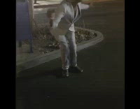 White suit blond wig guy dances asphalt 
