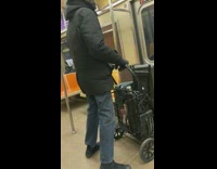 Guy brings speaker in cart on subway 