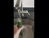 Sliced cucumber under the faucet water
