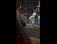 Woman wears playboy costume poses on street