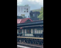 Woman filling up inflatable pool on rooftop