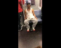 Grey sweatpants guy listens to music train 