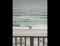 Collab IITW - Man and Woman beach outfit hold hands with camera behind