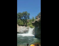 Guy tries to backflip off rock but bellyflops into waterfall