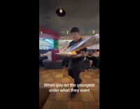 Waiter brings dragon shaped plate