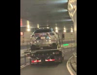 Chrome car being towed in throw the tunnel