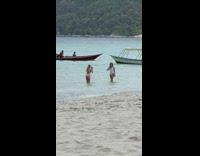 Woman in white bikini walks towards her friend Part 2