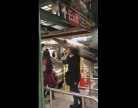 man carrying large fake missile through subway 