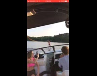 Guy rides wakeboard and glides across water on lake