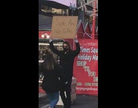 Guy holds sign that says socks are not gifts