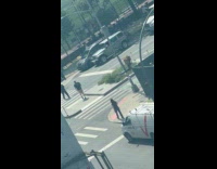 Man pull-ups on the traffic light post