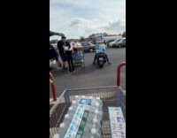 Man drives the motorcycle full of groceries