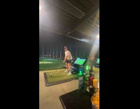 Lightning strikes behind the man at Topgolf