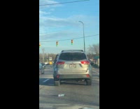 Woman drive SUV throws bottles at filmer car