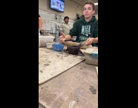 Man splashing water at friend during class 