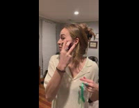 Girl using a red beet as makeup blush on her face