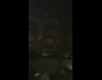 Man records a speech on the street at night