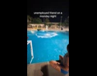 Man jumps from diving board with outdoor umbrella 