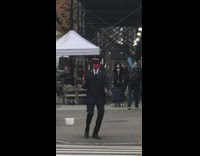Salvation army guy dances with bell sidewalk 