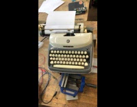 Woman makes typewriter writing on its own
