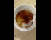 Milk poured into hot tea in mug