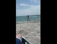 Girl yellow bottom bikini run beach awkwardly
