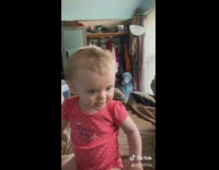 Little baby girl lowers head evil stare 