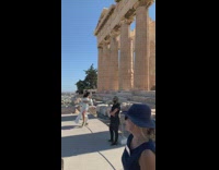 Woman white dress dramatic pose and walk on the ruins