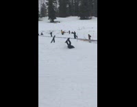 Snowboarder grinds rail fail falls in snow