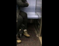 Girl on subway cuts hair using scissors 