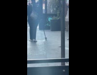 Woman walk street hold cane with boot