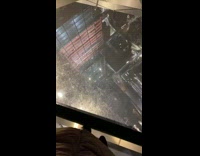 Collab Kale Salad IG -  Guy walks on glass floor tall building