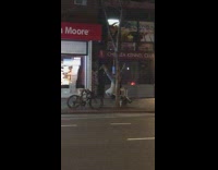 man upside down playing music from tree