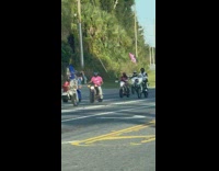 Horde of motorcycles and ATV on road